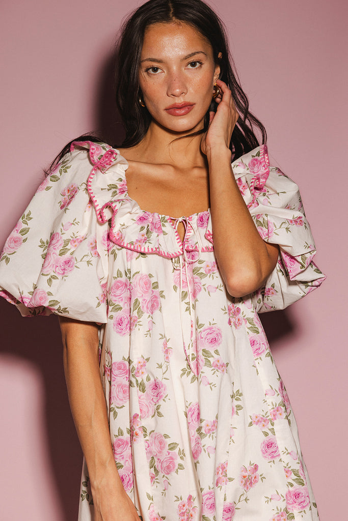 a pink floral puff sleeve dress with a ruffle neckline. the perfect vintage-inspired dress for baby showers, family pictures, + special occasions.