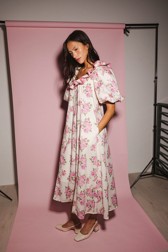 a pink floral puff sleeve dress with a ruffle neckline. the perfect vintage-inspired dress for baby showers, family pictures, + special occasions.