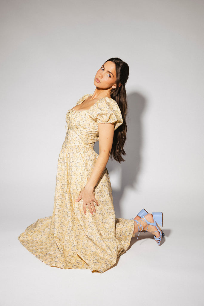 vintage-inspired puff sleeve dress with a muted yellow floral pattern. the perfect puff sleeve midi dress for weddings, bridal showers, + semi-formal events.