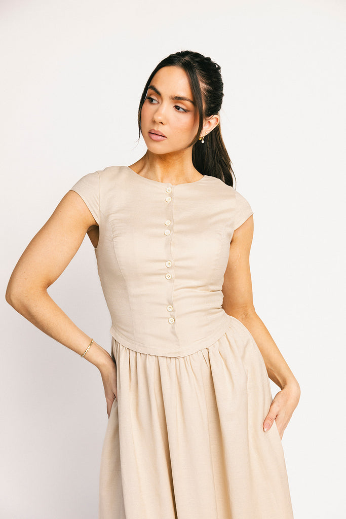 vintage-inspired dress with a fitted button-up bodice. the perfect neutral short sleeve dress for family pictures, bridal showers, + semi-formal events.