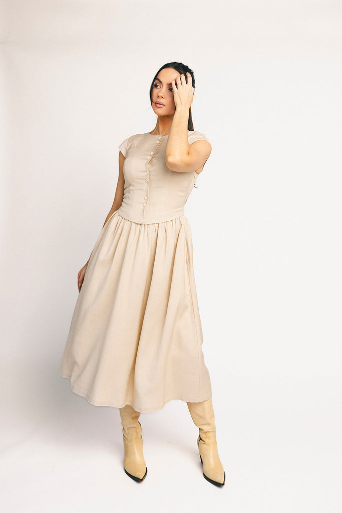 vintage-inspired dress with a fitted button-up bodice. the perfect neutral short sleeve dress for family pictures, bridal showers, + semi-formal events.