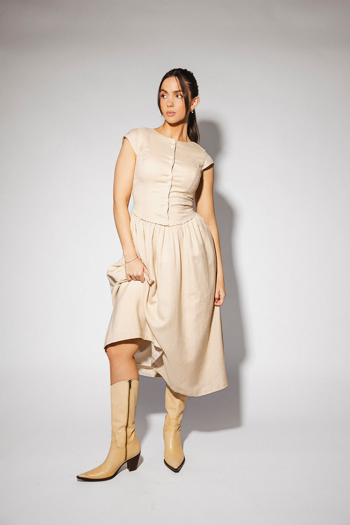 vintage-inspired dress with a fitted button-up bodice. the perfect neutral short sleeve dress for family pictures, bridal showers, + semi-formal events.