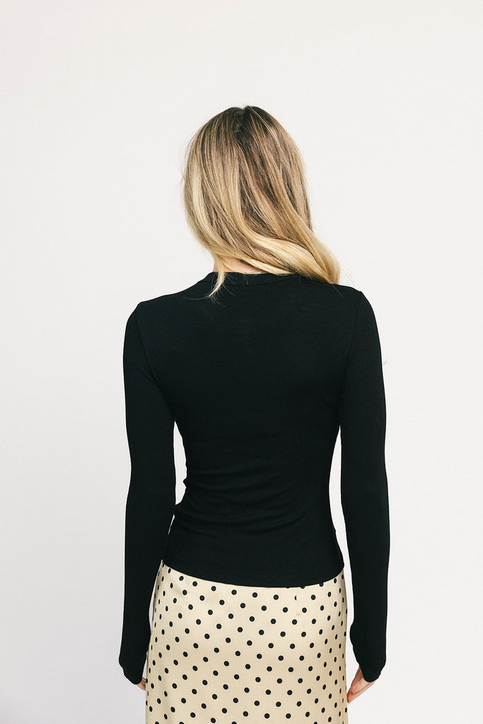 a stretchy black cardigan with a fitted silhouette. the perfect elevated basic for everyday wear + casual outfit styling.