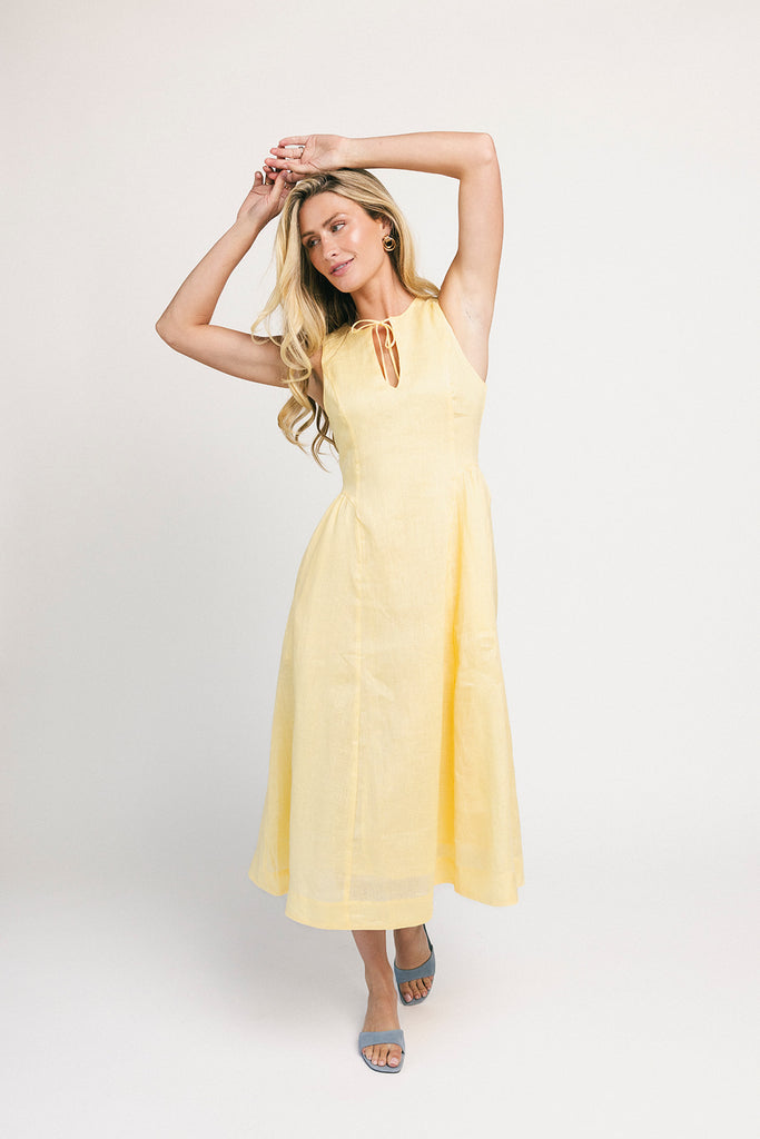 a classic yellow midi dress with a fitted bodice + a v waistline. the perfect vintage-inspired yellow dress for weddings, bridal showers, + garden parties.