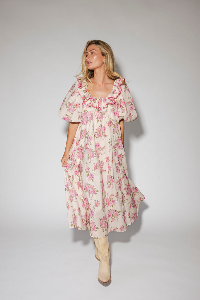 a pink floral puff sleeve dress with a ruffle neckline. the perfect vintage-inspired dress for baby showers, family pictures, + special occasions.