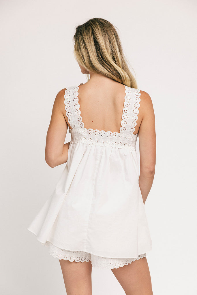 a white tank with a babydoll style silhouette + eyelet details. pair it with the matching white shorts to create the perfect two piece set for brunch dates, vacations, + everyday wear.