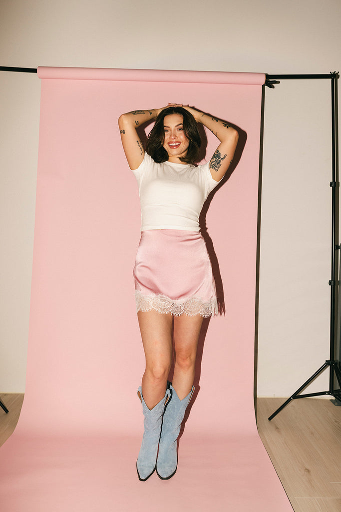 pink satin mini skirt with lace trim. perfect for date night outfits, semi formal outfits, and everyday wear.