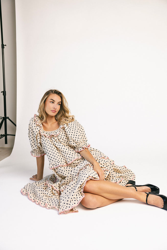 zoco daymaker dress: puff sleeve polka dot dress with an elastic neckline and pink trim details. perfect for weddings, baby showers, and family pictures.