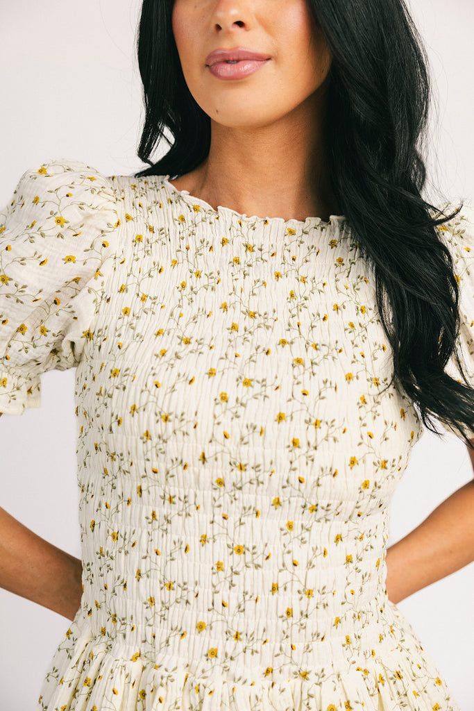 a floral puff sleeve dress with a smocked bodice + mini length. the perfect ditsy floral dress for family pictures, bridal showers, + brunch dates.