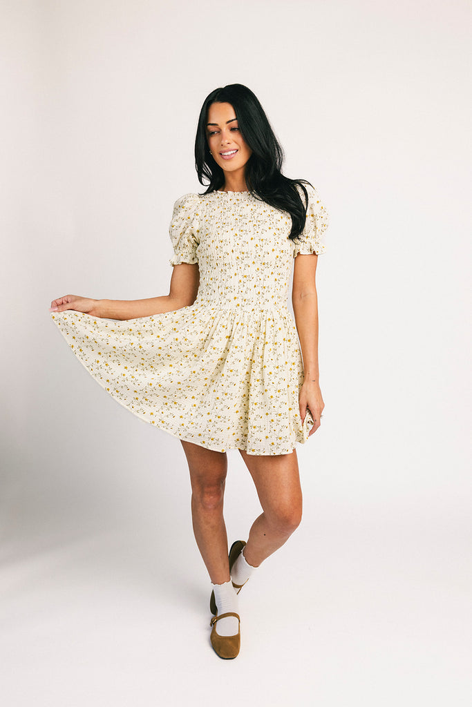 a floral puff sleeve dress with a smocked bodice + mini length. the perfect ditsy floral dress for family pictures, bridal showers, + brunch dates.