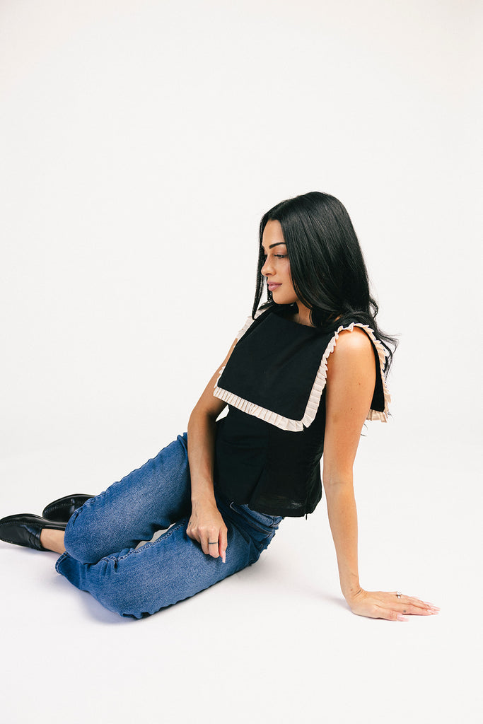 a vintage-inspired fitted tank with an oversized ruffle collar detail. the perfect elevated top for the office + dressy date nights.