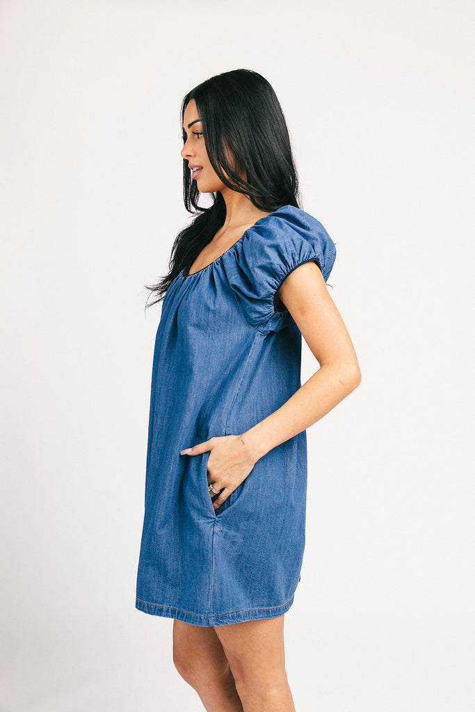 a puff sleeve denim dress with a mini length + black trim details. the perfect denim mini dress for date nights, family pictures, + everyday wear.