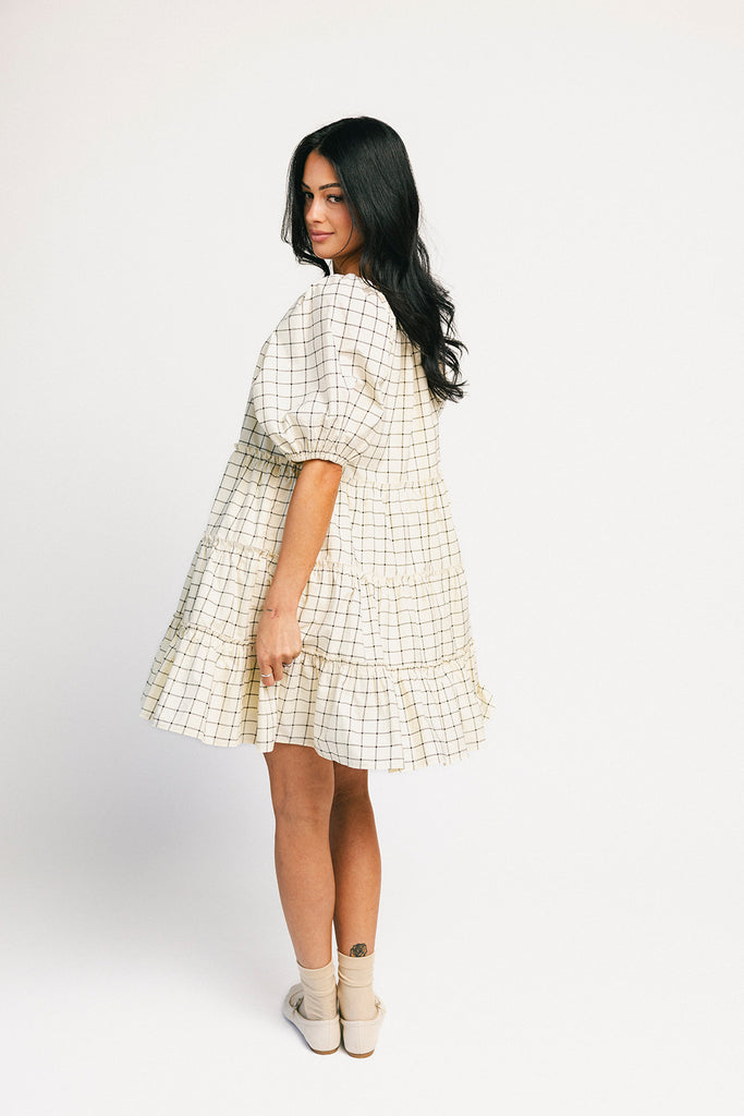 zoco daymaker dress: a short puff sleeve dress with a grid-style pattern + an elastic neckline. perfect for family pictures, weddings, and baby showers.