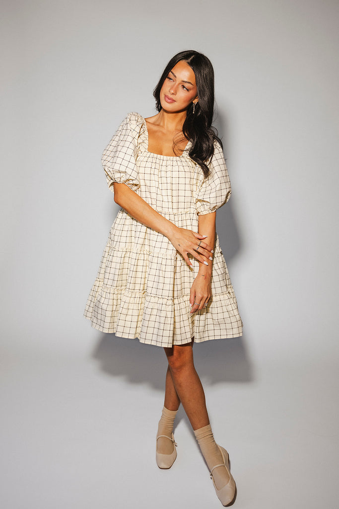 zoco daymaker dress: a short puff sleeve dress with a grid-style pattern + an elastic neckline. perfect for family pictures, weddings, and baby showers.