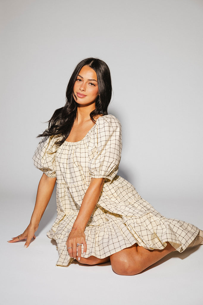 zoco daymaker dress: a short puff sleeve dress with a grid-style pattern + an elastic neckline. perfect for family pictures, weddings, and baby showers.