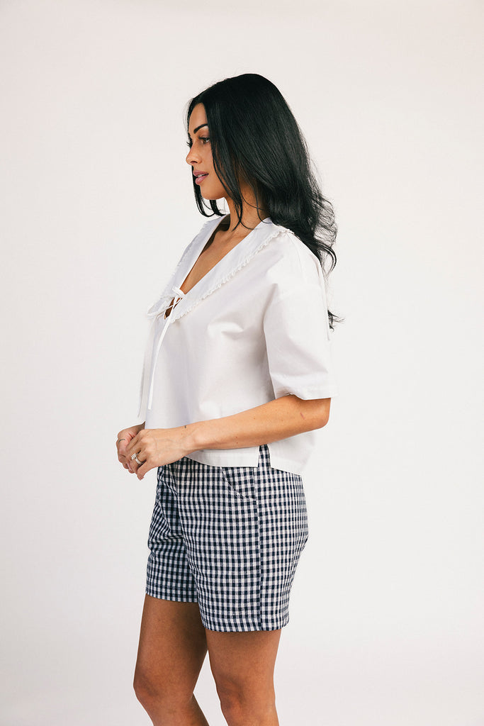 navy blue gingham vintage-inspired shorts with an elastic waist + longline silhouette. the perfect gingham shorts for everyday wear + casual outfit styling.