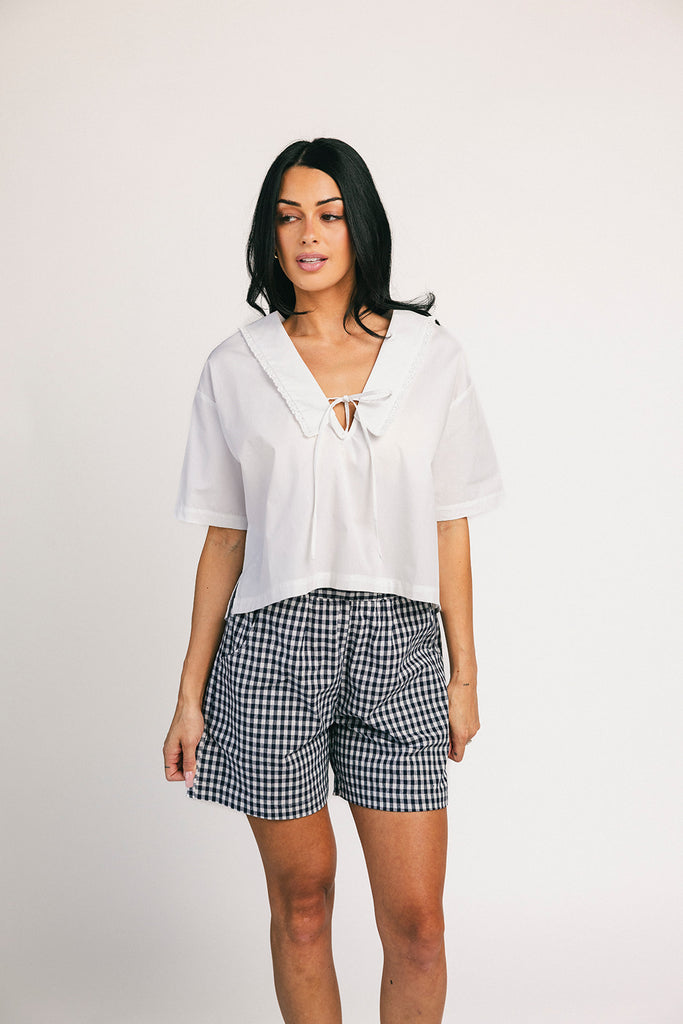 navy blue gingham vintage-inspired shorts with an elastic waist + longline silhouette. the perfect gingham shorts for everyday wear + casual outfit styling.