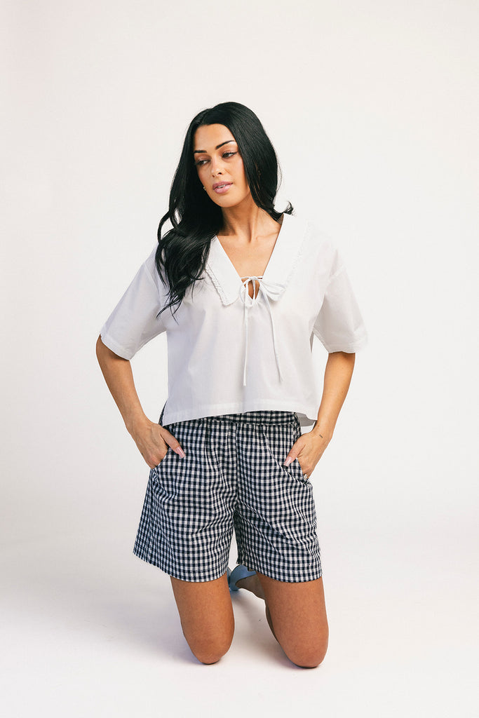 navy blue gingham vintage-inspired shorts with an elastic waist + longline silhouette. the perfect gingham shorts for everyday wear + casual outfit styling.