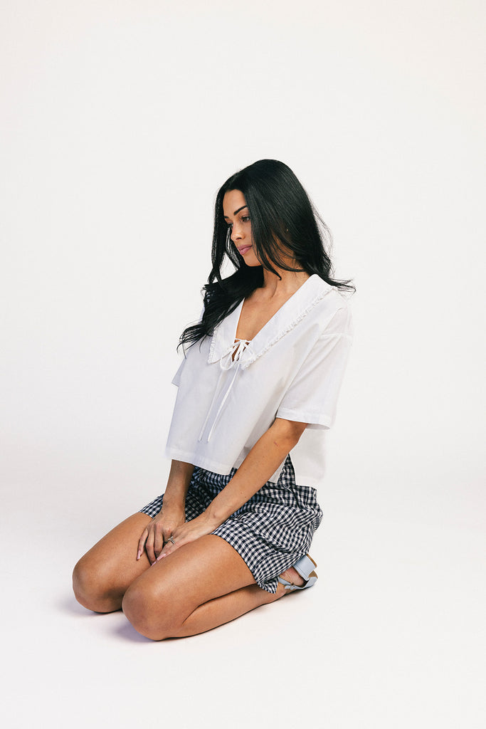 navy blue gingham vintage-inspired shorts with an elastic waist + longline silhouette. the perfect gingham shorts for everyday wear + casual outfit styling.