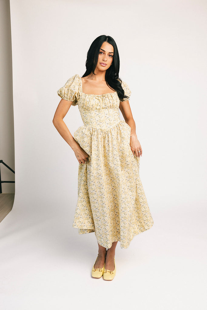 vintage-inspired puff sleeve dress with a muted yellow floral pattern. the perfect puff sleeve midi dress for weddings, bridal showers, + semi-formal events.