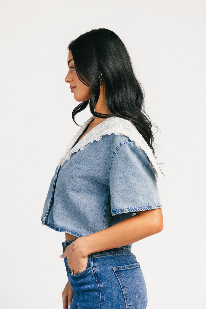 a short sleeve denim top with an oversized lace collar + a cropped silhouette. the perfect button up denim top to dress up or down for any outfit idea.