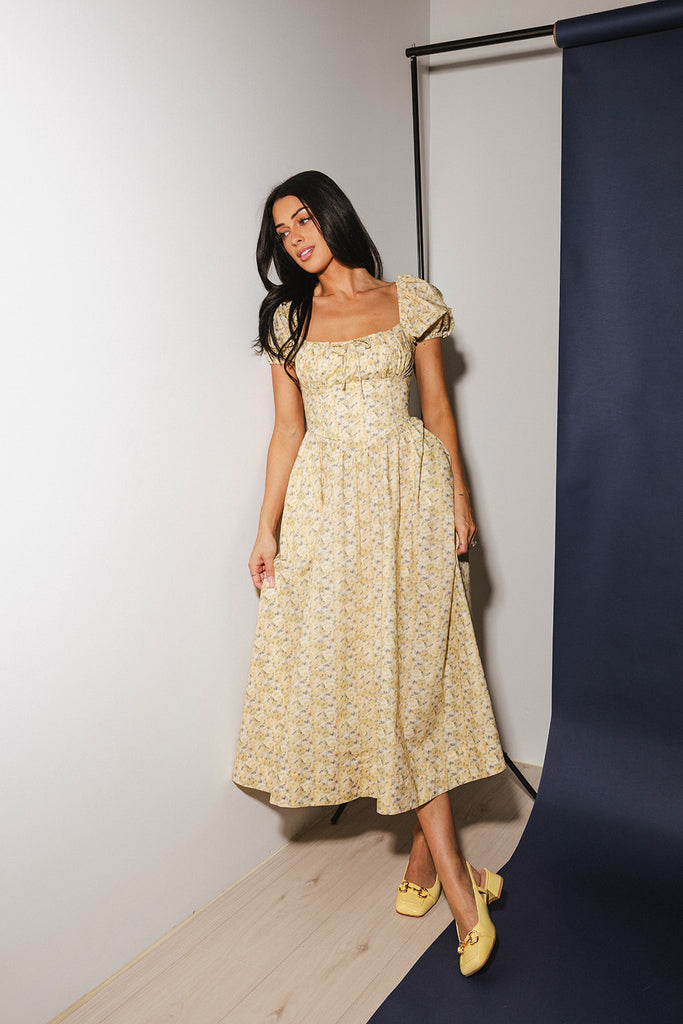 vintage-inspired puff sleeve dress with a muted yellow floral pattern. the perfect puff sleeve midi dress for weddings, bridal showers, + semi-formal events.
