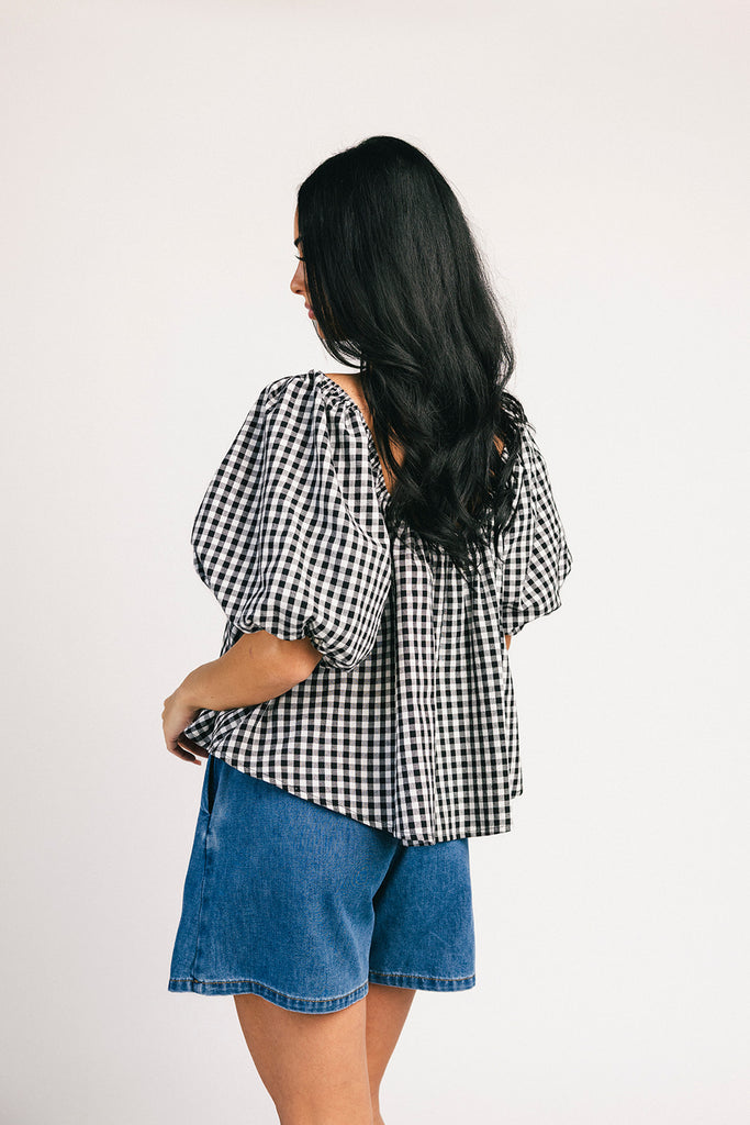 black and white gingham puff sleeve top with an elastic neckline + bow detail. the perfect elevated basic top for date nights + casual outfits.