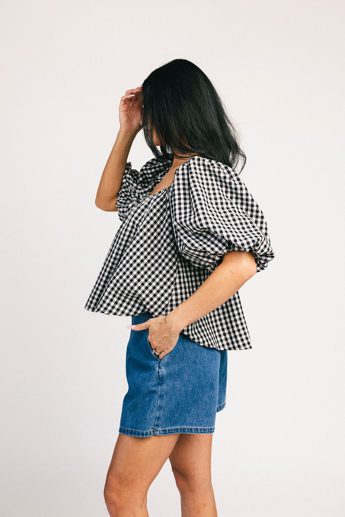 black and white gingham puff sleeve top with an elastic neckline + bow detail. the perfect elevated basic top for date nights + casual outfits.