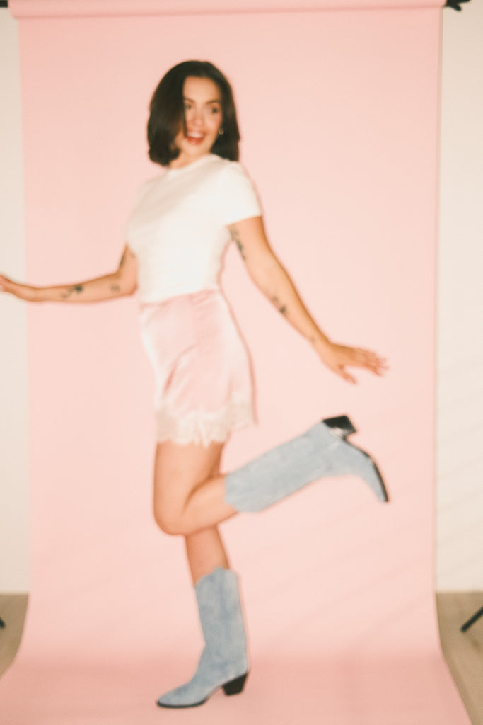 pink satin mini skirt with lace trim. perfect for date night outfits, semi formal outfits, and everyday wear.