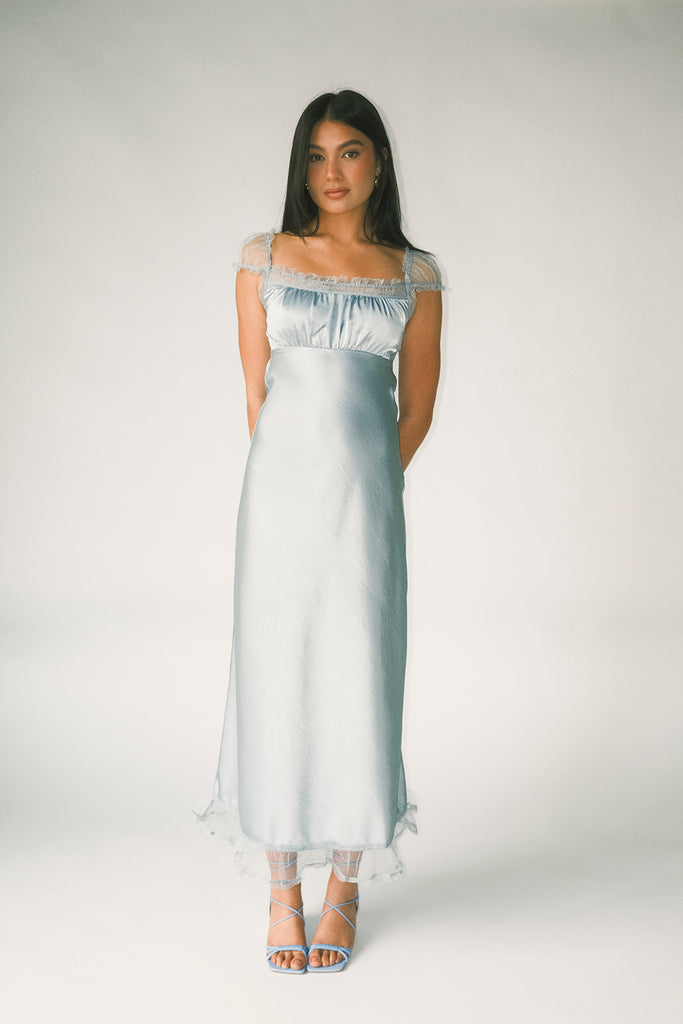 a light blue silk midi dress with lace detailing + a fitted silhouette. the perfect short sleeve occasion dress for weddings, bridal showers, + dinner parties.