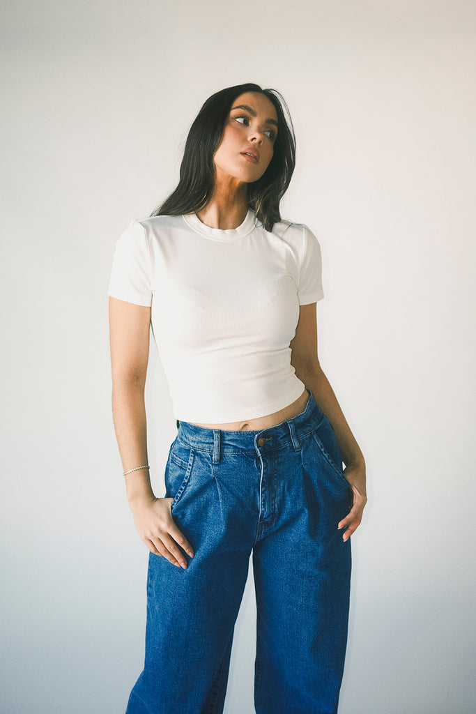 a classic plain white baby tee with a slightly cropped silhouette. the perfect fitted white t-shirt for everyday wear + casual outfit styling.