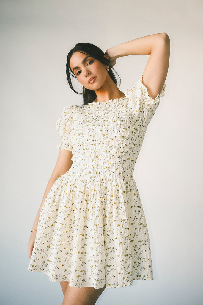 a floral puff sleeve dress with a smocked bodice + mini length. the perfect ditsy floral dress for family pictures, bridal showers, + brunch dates.