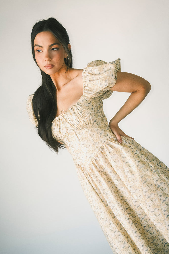 vintage-inspired puff sleeve dress with a muted yellow floral pattern. the perfect puff sleeve midi dress for weddings, bridal showers, + semi-formal events.