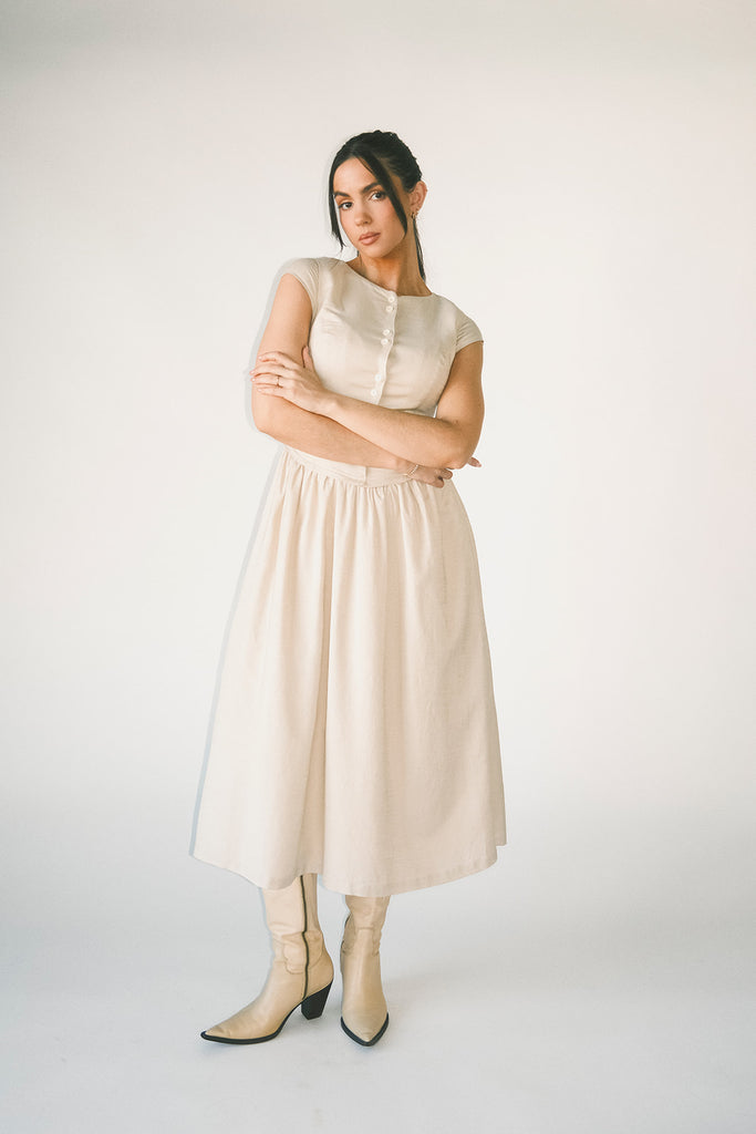 vintage-inspired dress with a fitted button-up bodice. the perfect neutral short sleeve dress for family pictures, bridal showers, + semi-formal events.