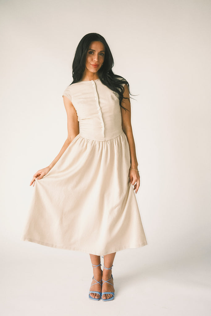 vintage-inspired dress with a fitted button-up bodice. the perfect neutral short sleeve dress for family pictures, bridal showers, + semi-formal events.