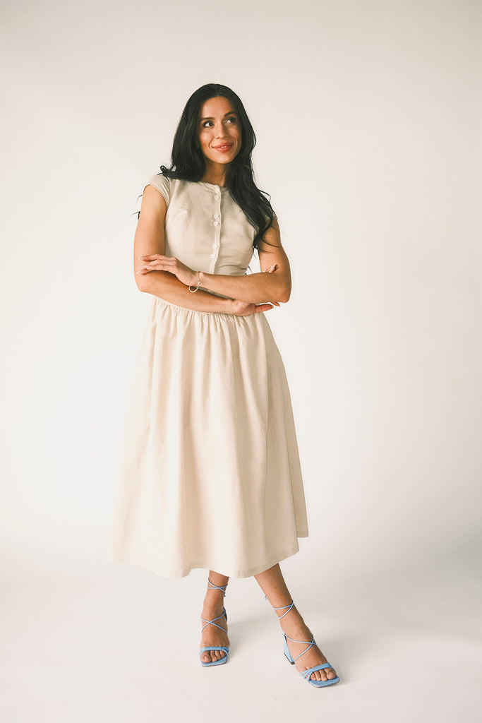 vintage-inspired dress with a fitted button-up bodice. the perfect neutral short sleeve dress for family pictures, bridal showers, + semi-formal events.