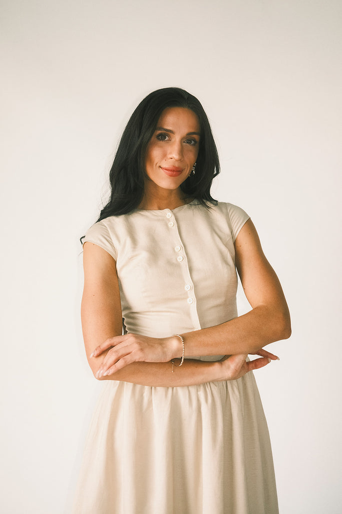 vintage-inspired dress with a fitted button-up bodice. the perfect neutral short sleeve dress for family pictures, bridal showers, + semi-formal events.