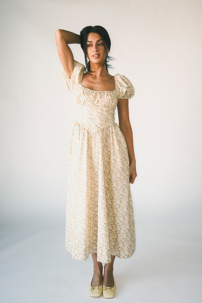 vintage-inspired puff sleeve dress with a muted yellow floral pattern. the perfect puff sleeve midi dress for weddings, bridal showers, + semi-formal events.