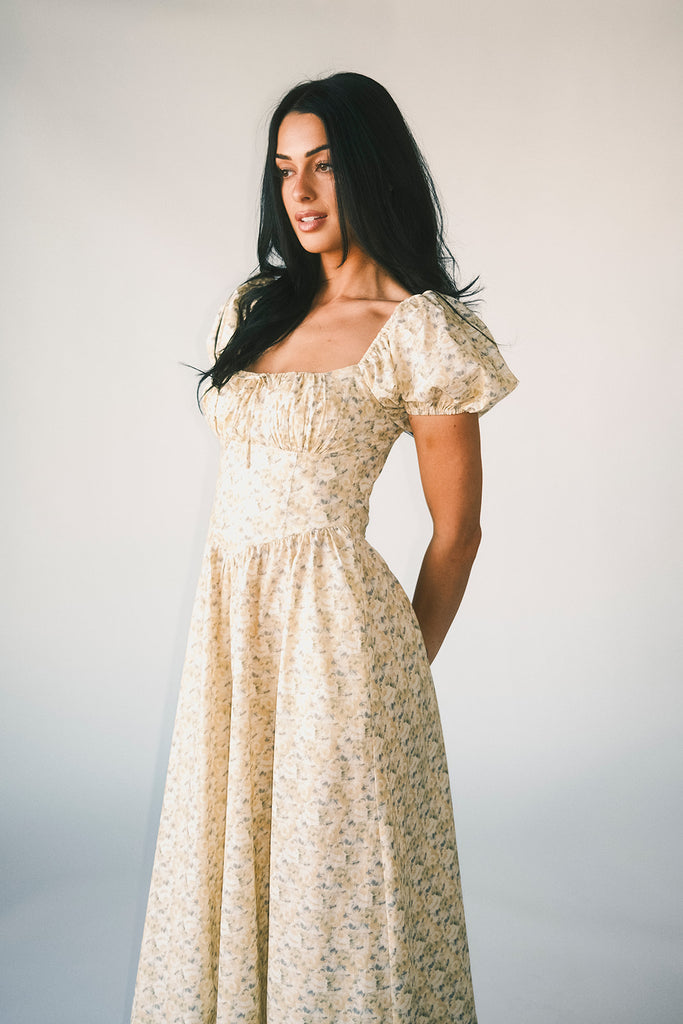 vintage-inspired puff sleeve dress with a muted yellow floral pattern. the perfect puff sleeve midi dress for weddings, bridal showers, + semi-formal events.