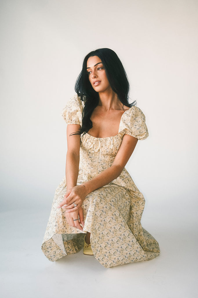 vintage-inspired puff sleeve dress with a muted yellow floral pattern. the perfect puff sleeve midi dress for weddings, bridal showers, + semi-formal events.