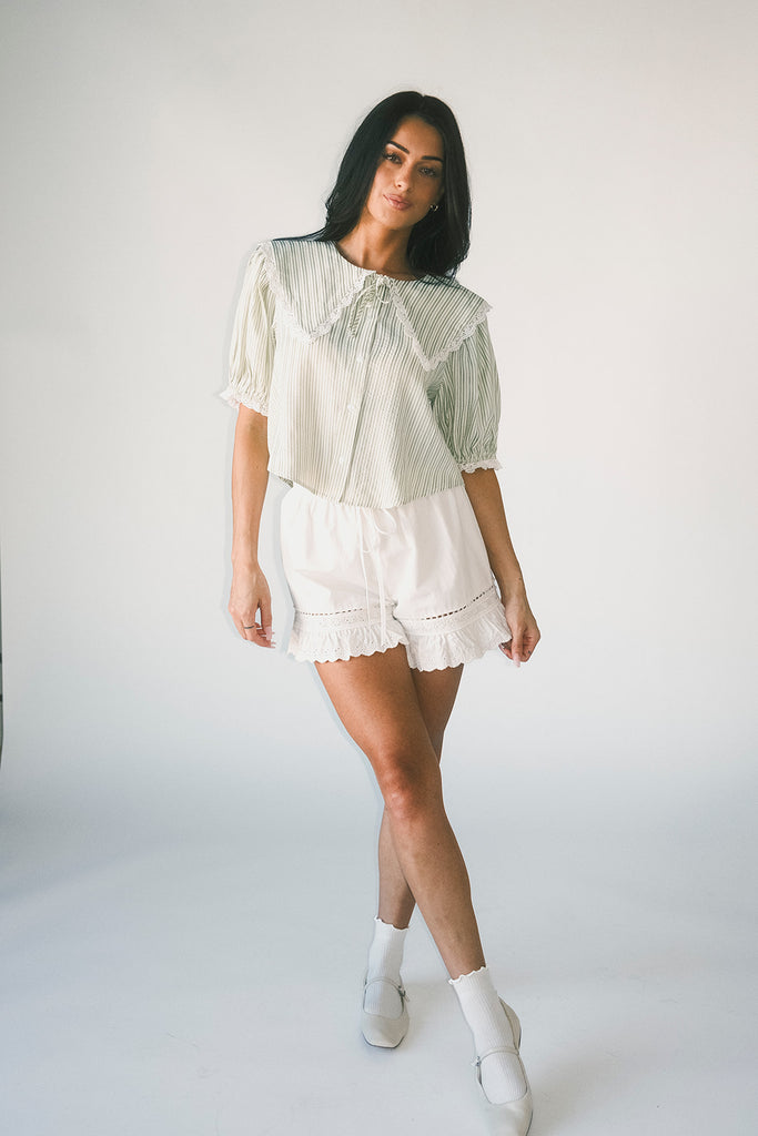 a vintage-inspired puff sleeve top with a pastel green pinstripe pattern + an oversized lace trim collar. the perfect elevated button up top for the office, dressy date nights, + everyday wear.