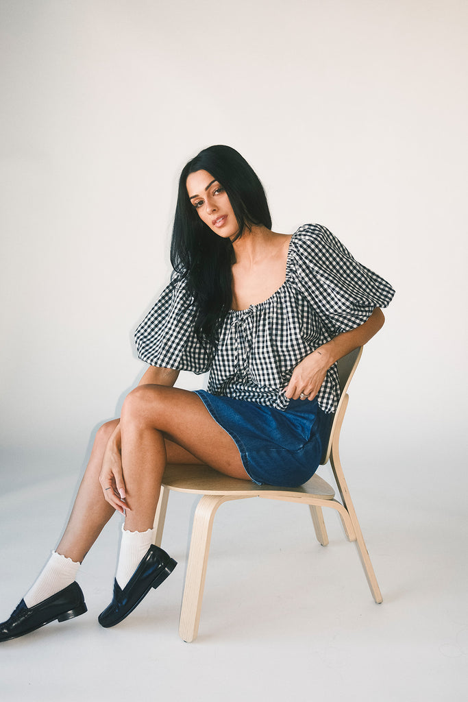 black and white gingham puff sleeve top with an elastic neckline + bow detail. the perfect elevated basic top for date nights + casual outfits.