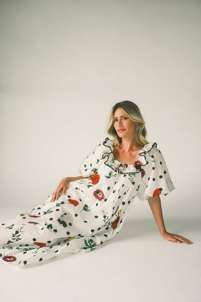 a polka dot puff sleeve dress with floral print details. the perfect polka dot midi dress for baby showers, family pictures, + special occasions.