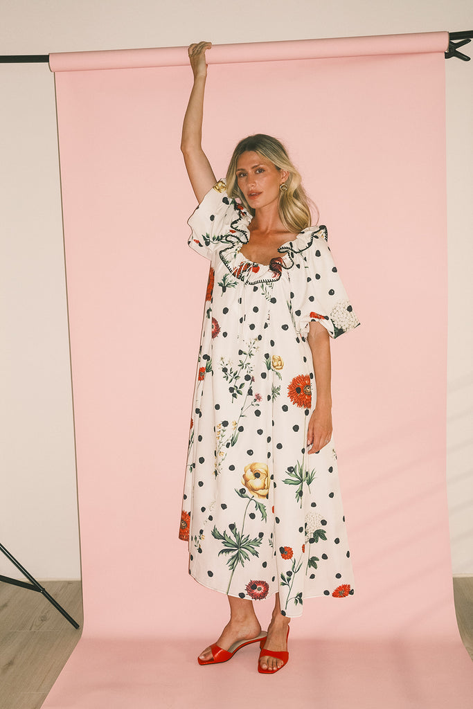 a polka dot puff sleeve dress with floral print details. the perfect polka dot midi dress for baby showers, family pictures, + special occasions.