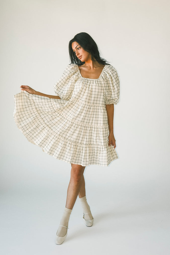 zoco daymaker dress: a short puff sleeve dress with a grid-style pattern + an elastic neckline. perfect for family pictures, weddings, and baby showers.