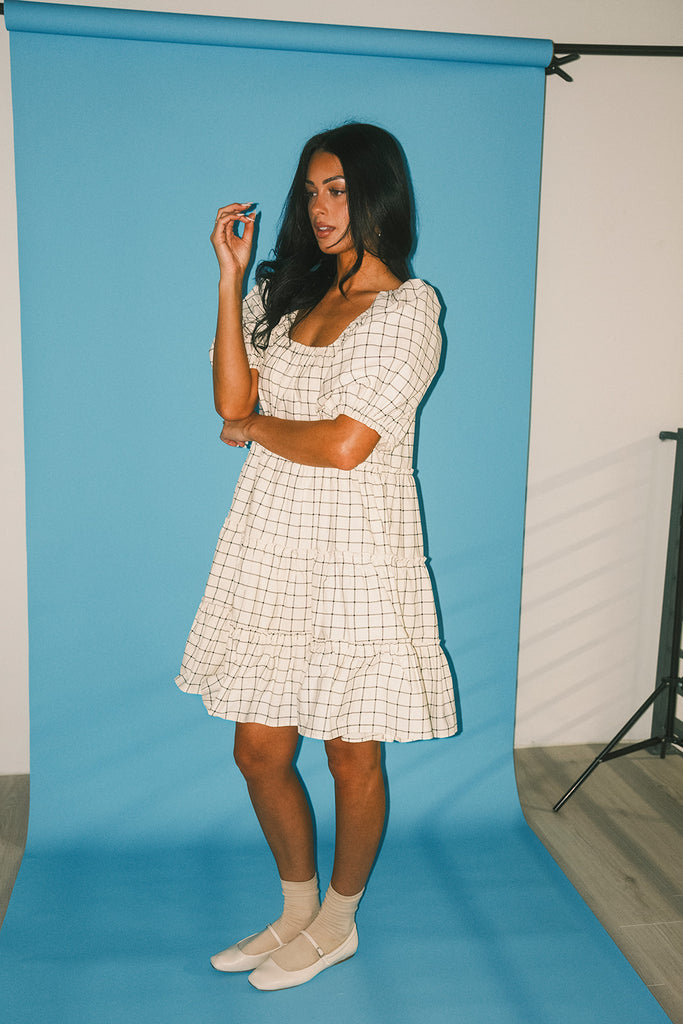 zoco daymaker dress: a short puff sleeve dress with a grid-style pattern + an elastic neckline. perfect for family pictures, weddings, and baby showers.