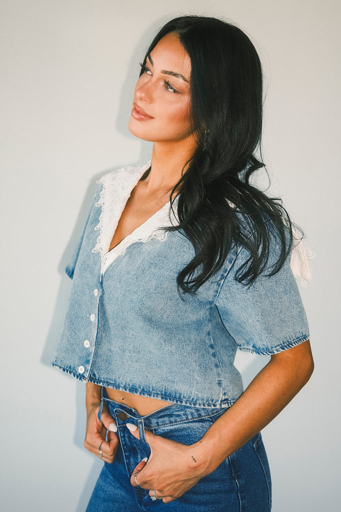 a short sleeve denim top with an oversized lace collar + a cropped silhouette. the perfect button up denim top to dress up or down for any outfit idea.