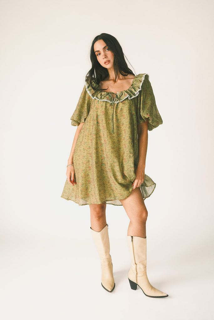 a green floral puff sleeve mini dress with a ruffle neckline. the perfect vintage-inspired dress for baby showers, family pictures, + special occasions.