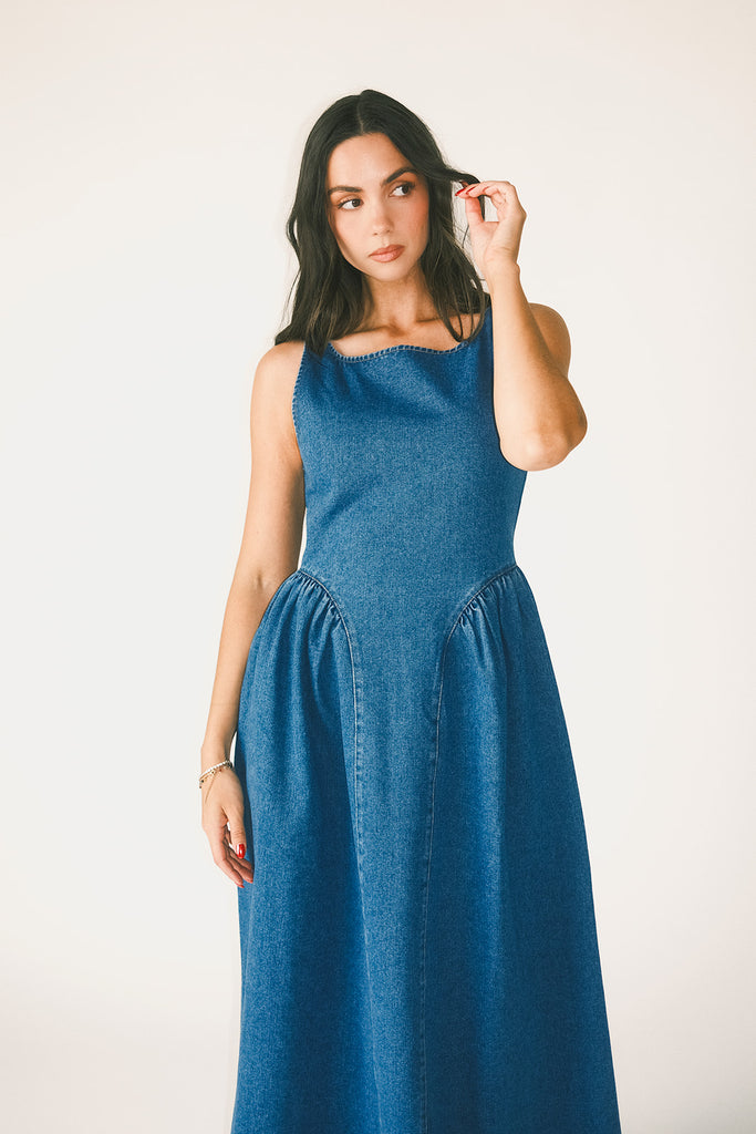 a vintage-inspired denim dress with a boat neckline + a v-shaped waistline. the perfect denim midi dress for family pictures, brunch dates, + special occasions.