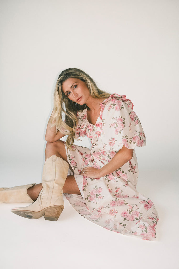 a pink floral puff sleeve dress with a ruffle neckline. the perfect vintage-inspired dress for baby showers, family pictures, + special occasions.
